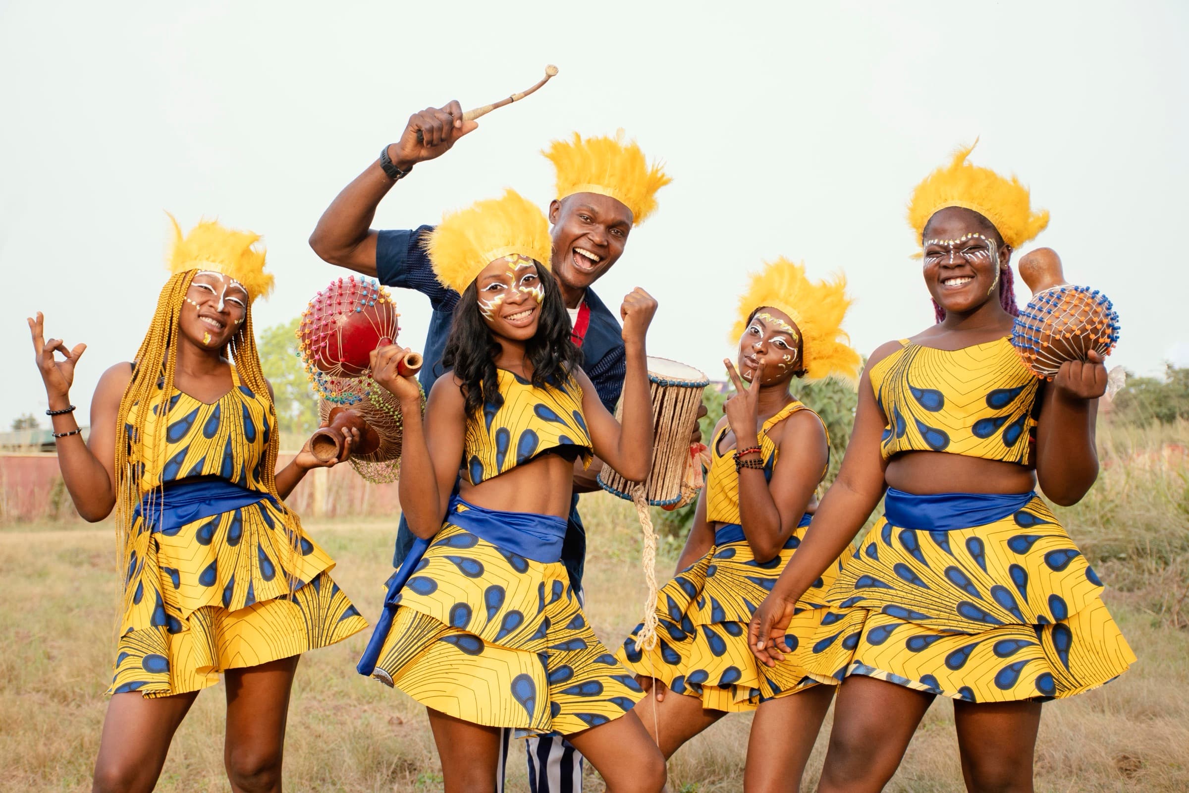 Friends in colourful costumes and feathered headdresses at a carnival