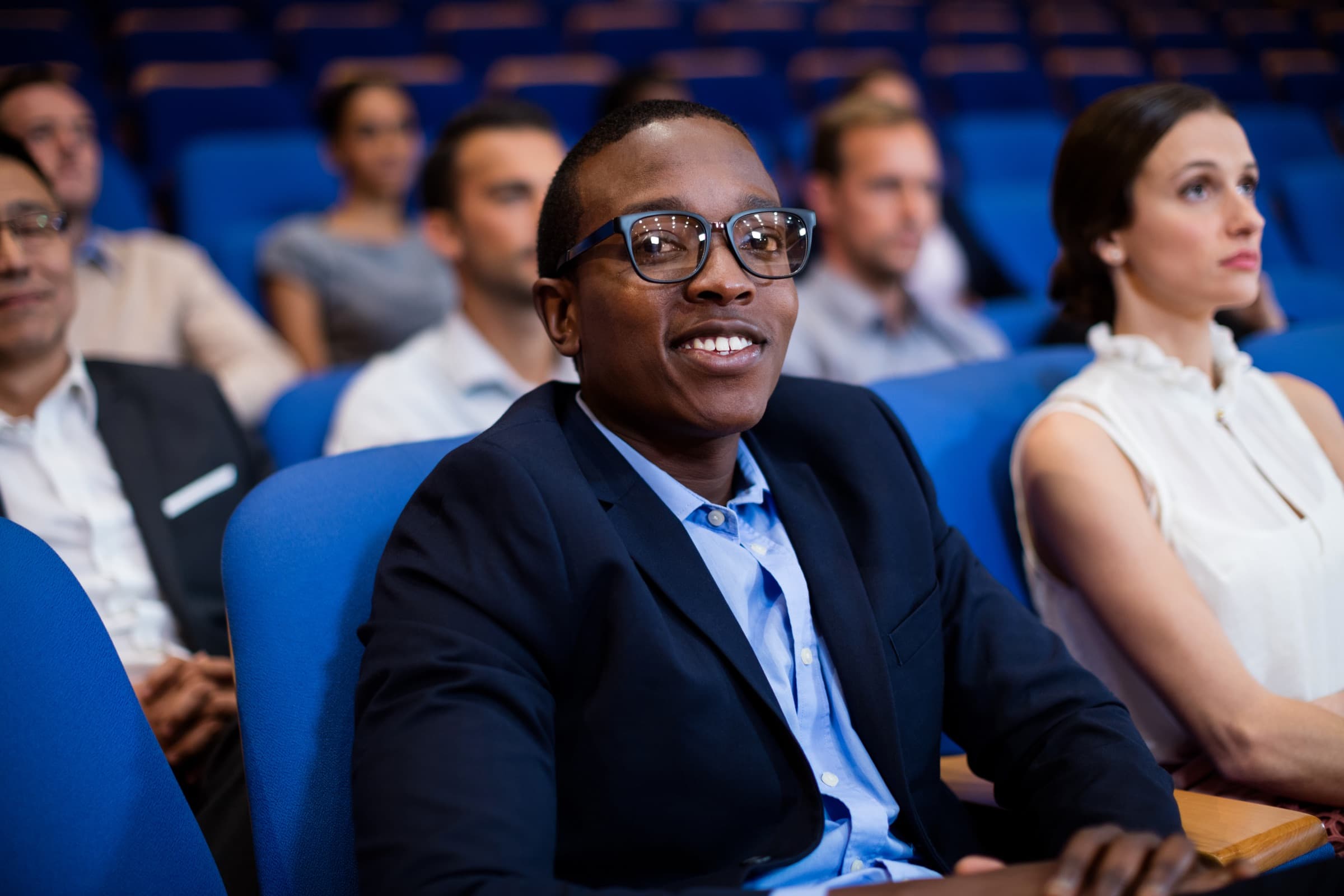 An attentive audience in the seats of a conference hall